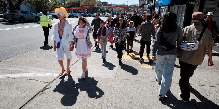 Tired cosplayers crossing the street